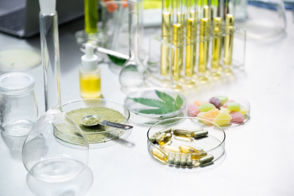 Selective focus Cannabis products including Powders, Oil, Infused gummy, Gel pills, and Cannabis Capsules on scientist table in the laboratory.Cannabis for medical concept